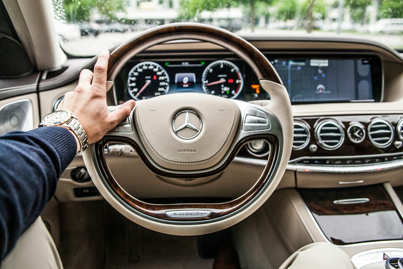 limo driver sitting in Mercedes-Benz driver seat providing NY celebrity transportation